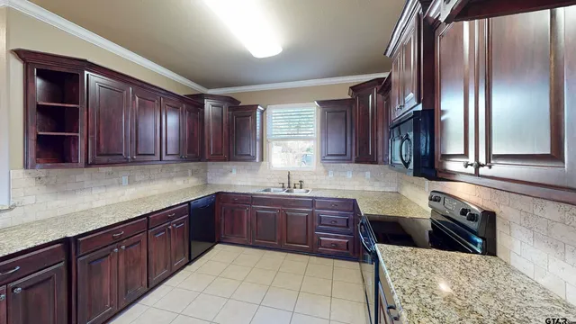 a kitchen with stainless steel appliances granite countertop wooden cabinets a sink and dishwasher