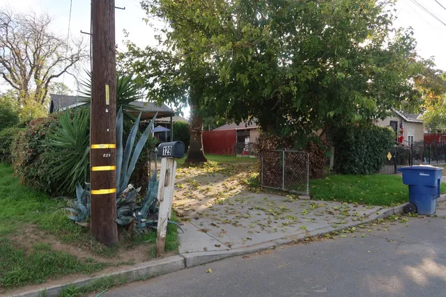 a view of a park with iron fence