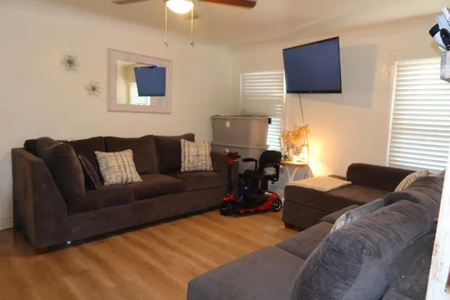 a living room with furniture and a flat screen tv