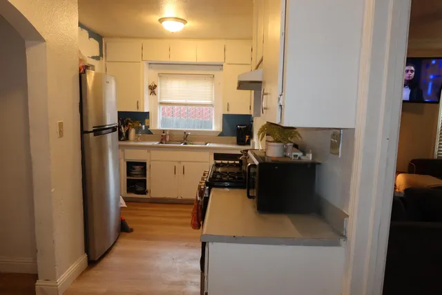 a kitchen with a sink appliances and a refrigerator