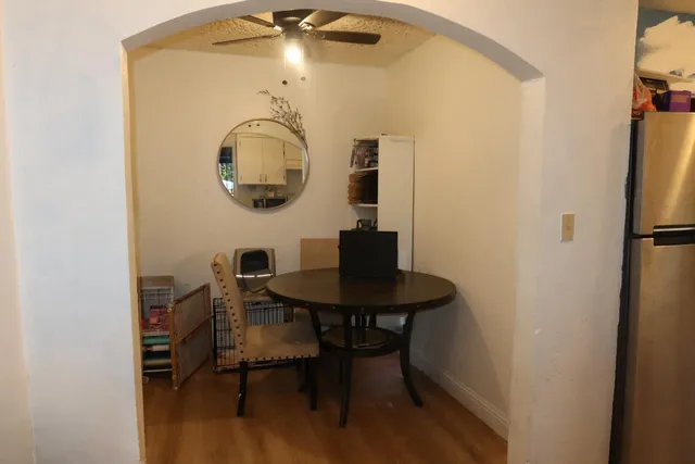 a view of a room with a table and chairs