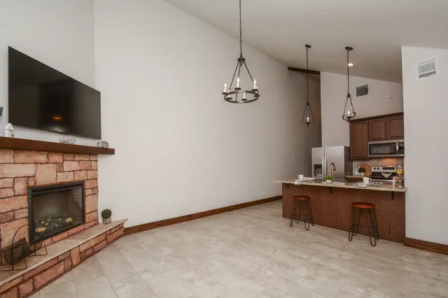a view of kitchen with granite countertop microwave and stove