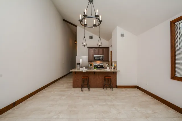 a view of kitchen and fireplace with empty space