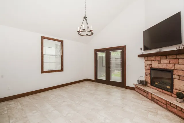 a view of a livingroom with a fireplace and a window