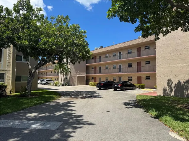 a view of a building with a yard