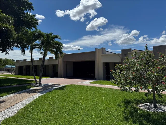 a backyard of a house with lots of green space and outdoor seating