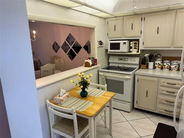 a kitchen with stainless steel appliances a stove a microwave a sink and cabinets