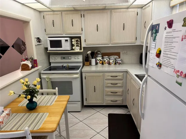 a kitchen with a stove and a refrigerator