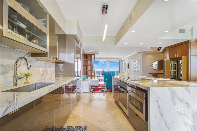 a kitchen with stainless steel appliances granite countertop a stove and a sink