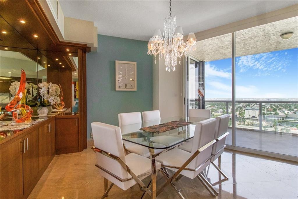 3100 North Ocean Boulevard, Unit 2103 Fort Lauderdale, FL 33308 - Photo 13 of 37 a dining room with furniture a chandelier and window