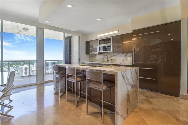 a kitchen with kitchen island granite countertop wooden floor dining table and chairs