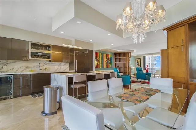 a living room with fireplace furniture and a chandelier