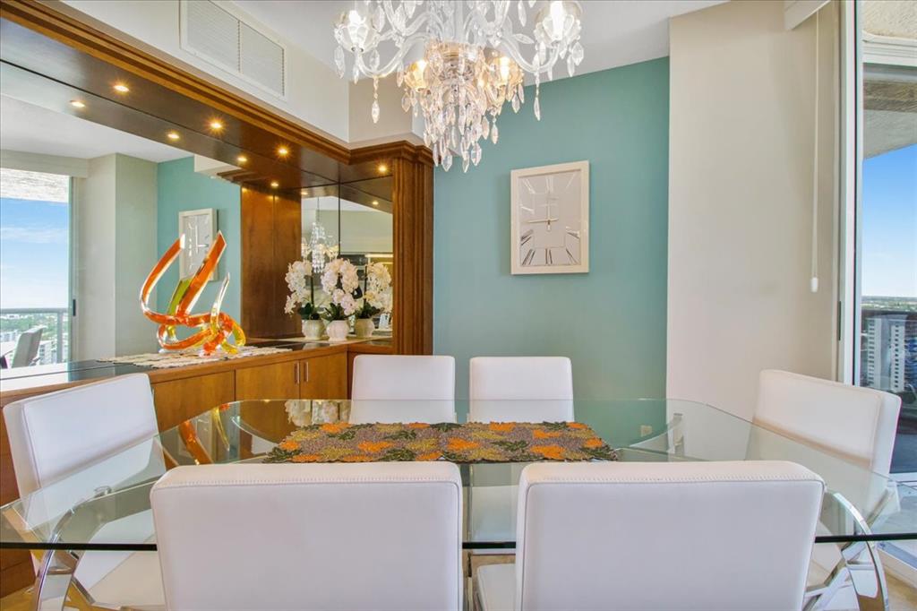 3100 North Ocean Boulevard, Unit 2103 Fort Lauderdale, FL 33308 - Photo 19 of 37 a living room with furniture a chandelier and a chandelier