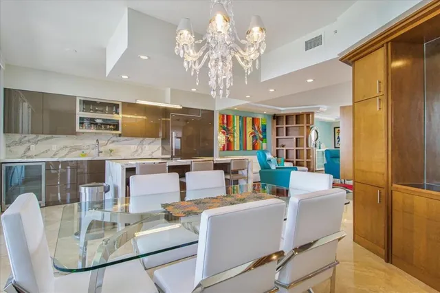a living room with stainless steel appliances granite countertop furniture and a kitchen view