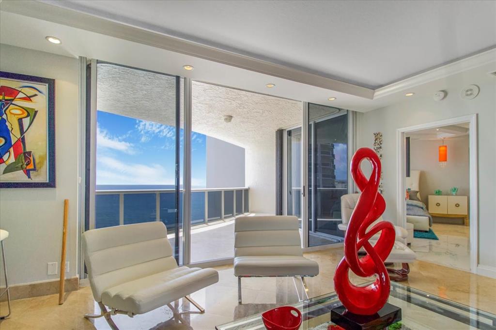 3100 North Ocean Boulevard, Unit 2103 Fort Lauderdale, FL 33308 - Photo 21 of 37 a living room with furniture a rug and wall painting