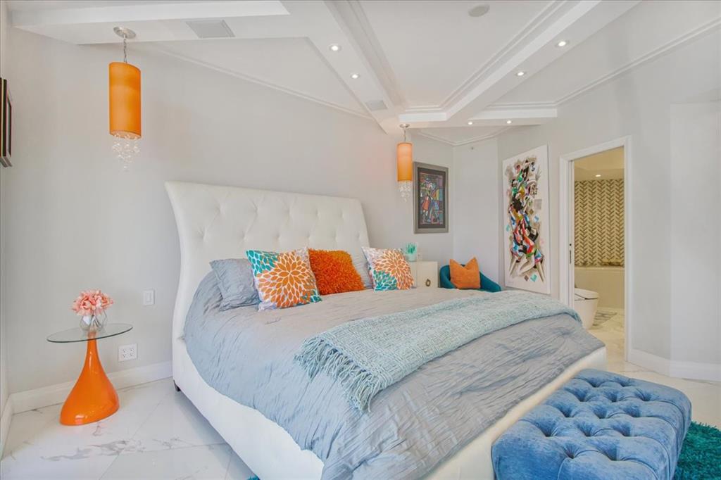 3100 North Ocean Boulevard, Unit 2103 Fort Lauderdale, FL 33308 - Photo 22 of 37 a bedroom with bed and a chandelier