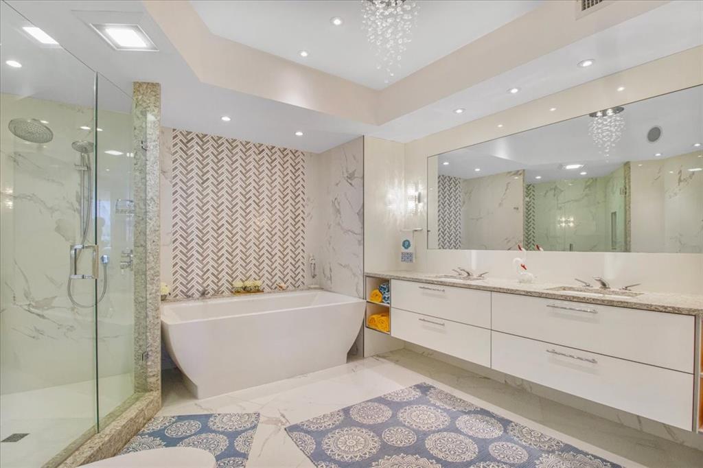 3100 North Ocean Boulevard, Unit 2103 Fort Lauderdale, FL 33308 - Photo 25 of 37 a bathroom with a bathtub and a shower