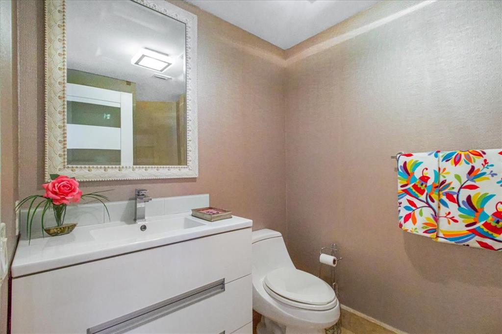 3100 North Ocean Boulevard, Unit 2103 Fort Lauderdale, FL 33308 - Photo 28 of 37 a bathroom with a sink vanity mirror and toilet