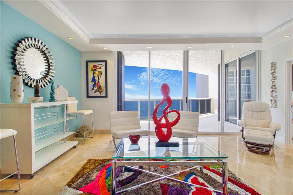 3100 North Ocean Boulevard, Unit 2103 Fort Lauderdale, FL 33308 - Photo 3 of 37 a room with furniture and a table