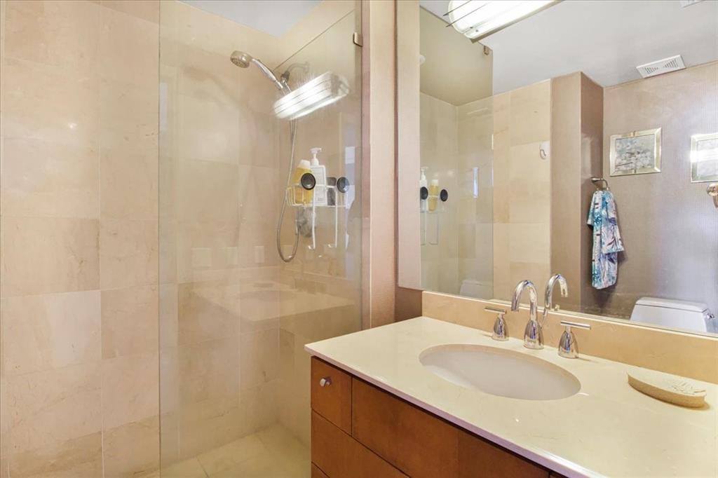 3100 North Ocean Boulevard, Unit 2103 Fort Lauderdale, FL 33308 - Photo 31 of 37 a bathroom with a sink vanity mirror and shower