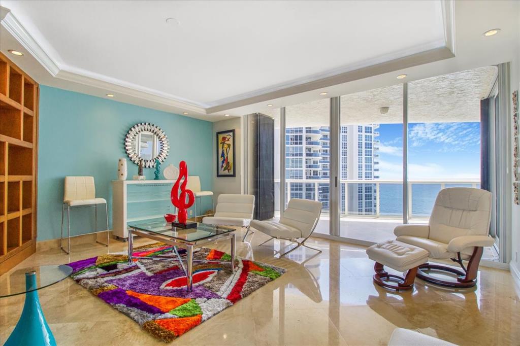 3100 North Ocean Boulevard, Unit 2103 Fort Lauderdale, FL 33308 - Photo 4 of 37 a living room with furniture and floor to ceiling window