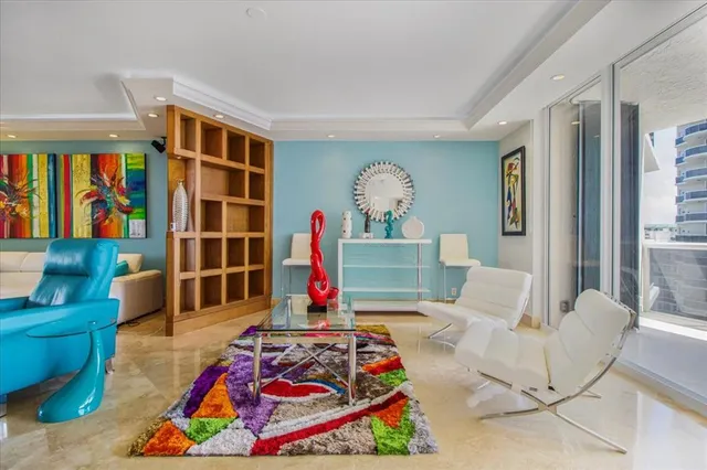 a living room with patio furniture and a rug