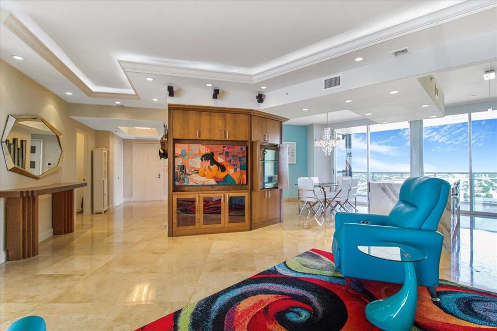 3100 North Ocean Boulevard, Unit 2103 Fort Lauderdale, FL 33308 - Photo 8 of 37 a living room with furniture and a flat screen tv