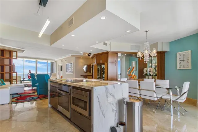 a kitchen with stainless steel appliances kitchen island granite countertop a stove and cabinets