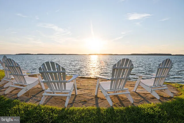 a living room with fireplace furniture and a large window