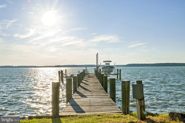 a dining room with furniture a large window and kitchen view