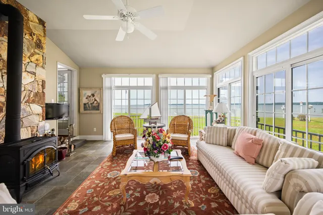 a living room with furniture a rug and a fireplace