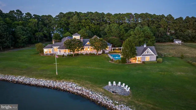 a view of a house with swimming pool and sitting area