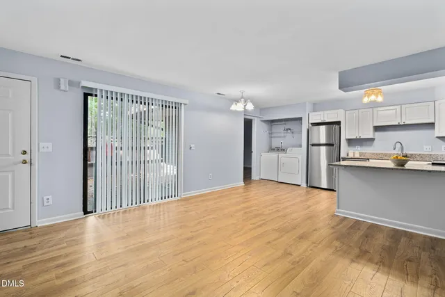 a view of a kitchen with a sink and cabinets
