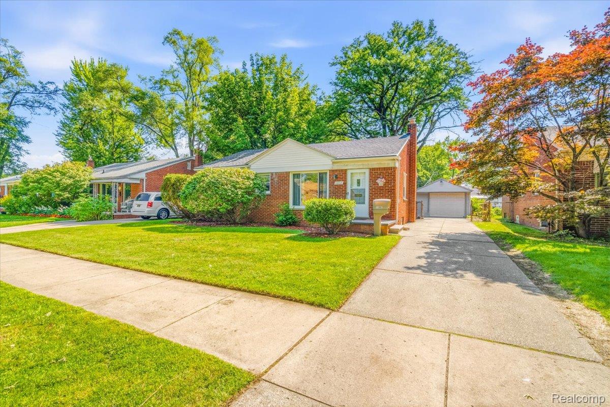 11802 Columbia Street Redford, MI 48239 - Photo 26 of 39 Solid Brick Ranch with a concrete driveway leading to a detached garage, and mature landscaping
