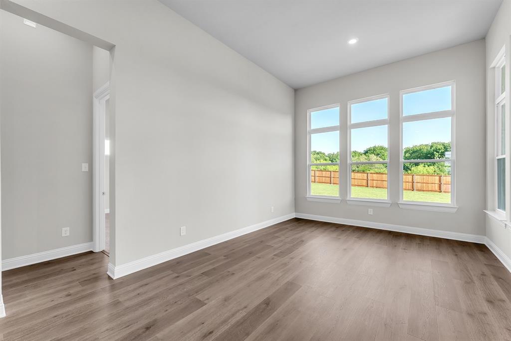 1215 Olive Drive Mansfield, TX 76063 - Photo 12 of 28 wooden floor in an empty room with a window