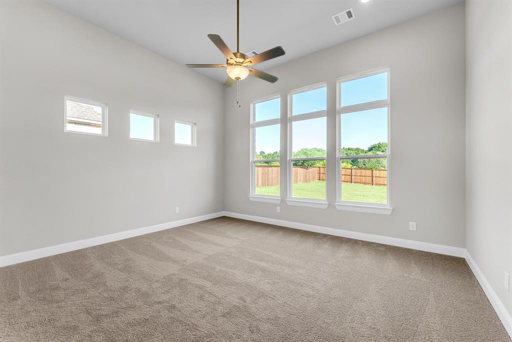 1215 Olive Drive Mansfield, TX 76063 - Photo 14 of 28 an empty room with windows and fan