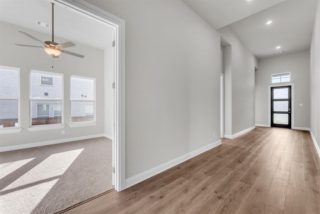 1215 Olive Drive Mansfield, TX 76063 - Photo 17 of 28 a view of an empty room with a window and wooden floor