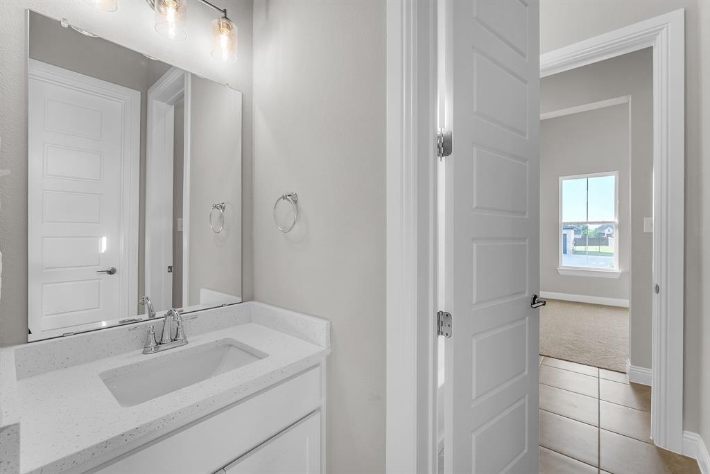 1215 Olive Drive Mansfield, TX 76063 - Photo 21 of 28 a bathroom with a sink and a mirror