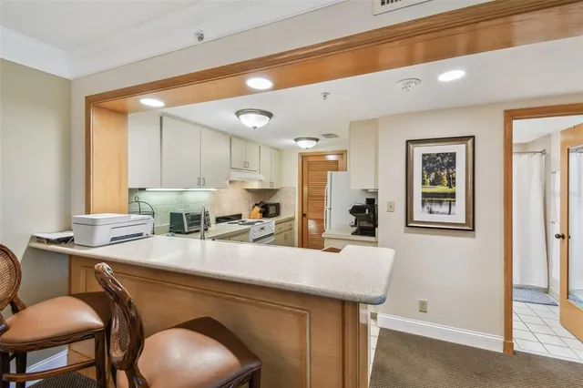 a kitchen with sink and refrigerator