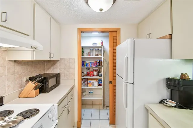a kitchen with a sink and a refrigerator