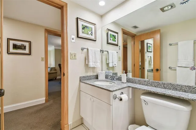 a bedroom with a bed and a view of kitchen