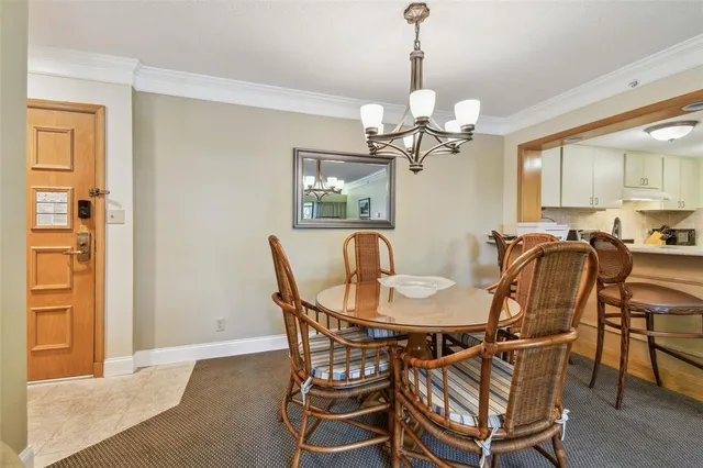 a view of a dining room with furniture and a chandelier