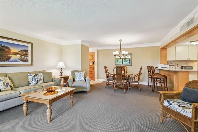 a living room with furniture and a chandelier