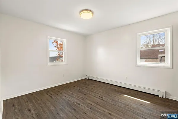 a view of a room with wooden floor and window