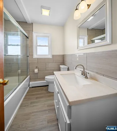 a bathroom with a sink a large mirror and a bathtub