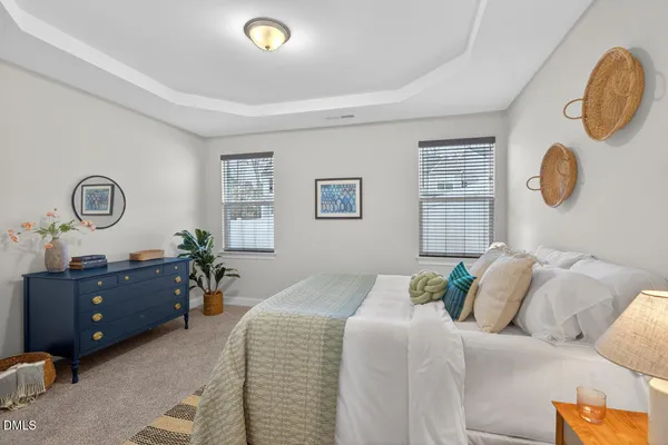 a bed room with a bed mirror and a window