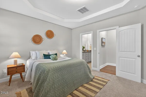 a bedroom with bed and a chandelier