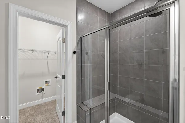 a bathroom with a glass shower door