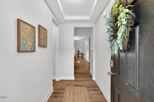 a view of a hallway with wooden floor and stairs