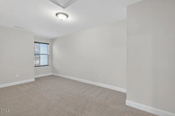 a view of an empty room and a window